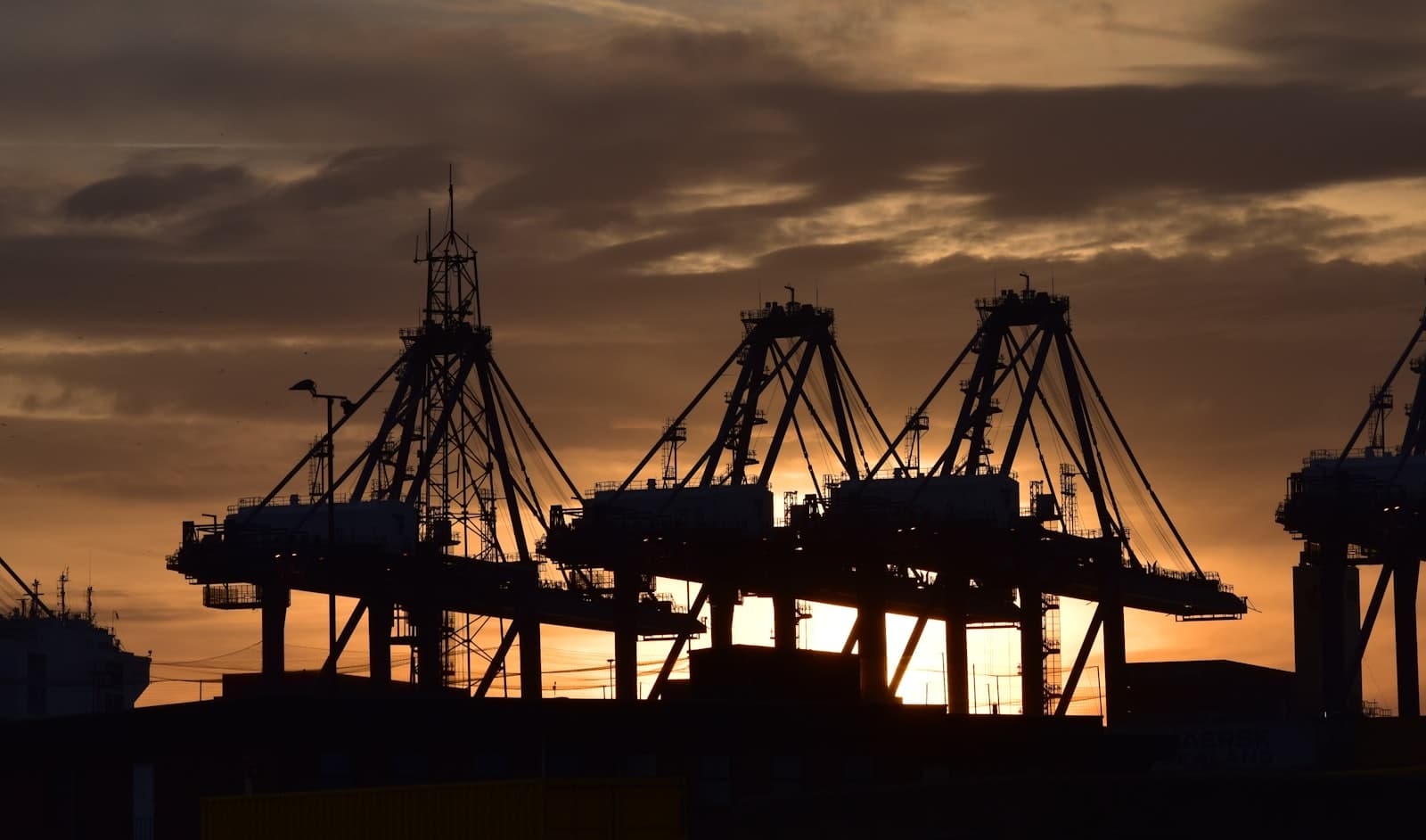Food cargo at an emerging-market port at sunrise, warm earthy tones